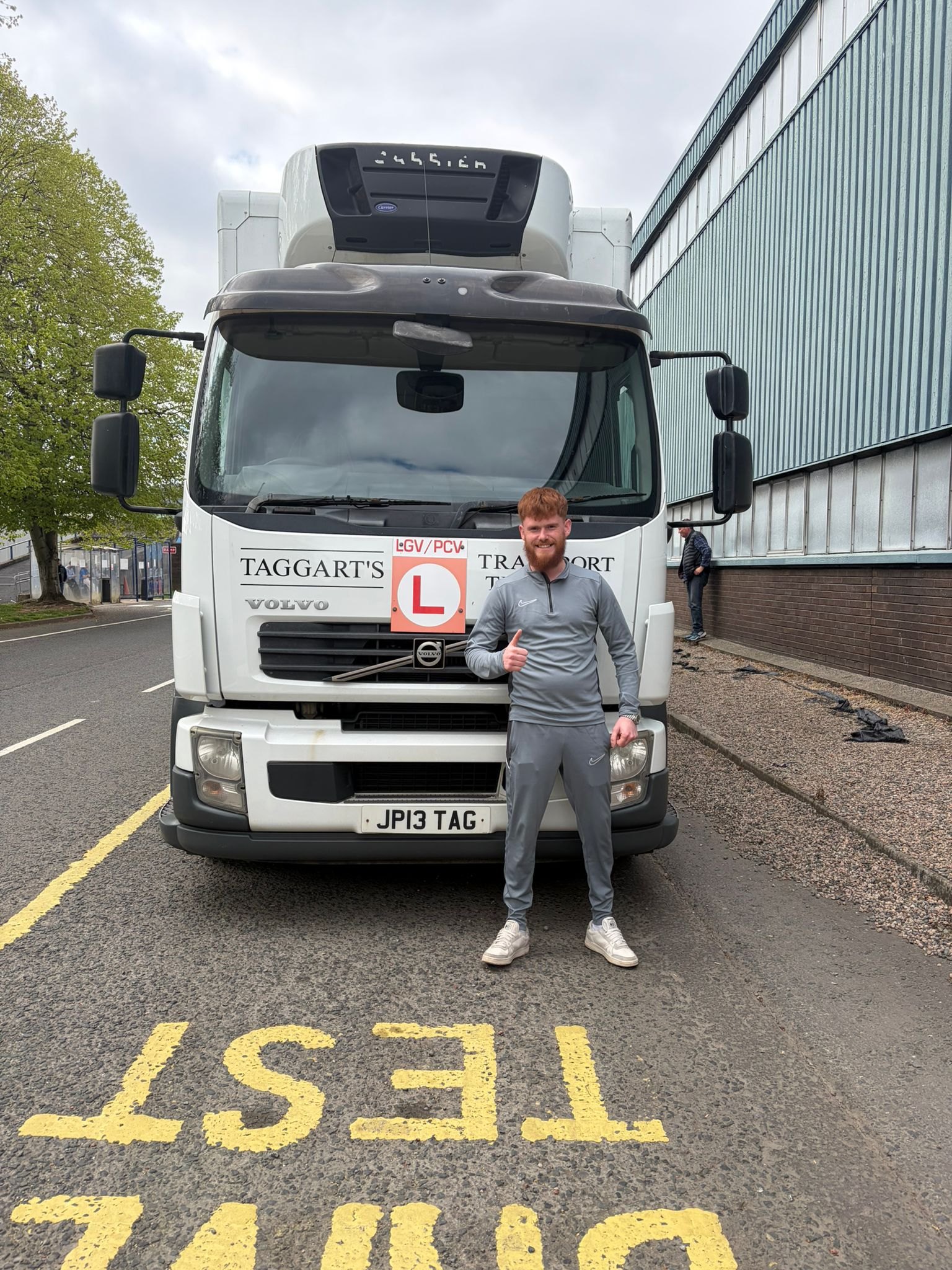 Learner standing beside an LGV training vehicle